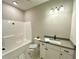 Bright bathroom features a tub/shower combo and a white vanity at 315 S Maple Ave, Kenly, NC 27542