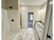 Bathroom boasting a shower, dual sink vanity and a doorway to bedroom at 315 S Maple Ave, Kenly, NC 27542