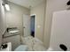 Bright bathroom features a tub/shower combo and a white vanity at 315 S Maple Ave, Kenly, NC 27542