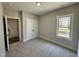 Bedroom featuring fresh paint, carpet, closet, and double hung window at 315 S Maple Ave, Kenly, NC 27542