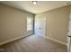 A clean bedroom with a window and a double door closet at 315 S Maple Ave, Kenly, NC 27542