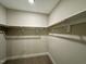 Walk-in closet with wooden clothing racks and wall-mounted shelves at 315 S Maple Ave, Kenly, NC 27542