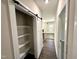 Hallway featuring a sliding barn door, white trim, and access to the rest of the home at 315 S Maple Ave, Kenly, NC 27542