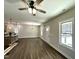 Bright open-concept living room featuring new floors and a ceiling fan at 315 S Maple Ave, Kenly, NC 27542