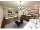 Open-concept living room featuring a kitchen island and dining area with modern decor and plenty of natural light at 315 S Maple Ave, Kenly, NC 27542