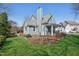 Side view of a charming home with a well-manicured lawn, inviting porch, and a fenced backyard at 3213 Leebrook Rd, Raleigh, NC 27616