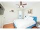 Bedroom with hardwood floors, ceiling fan, and a comfortable bed with white bedding at 3800 Long Meadow Dr, Mebane, NC 27302