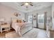 Serene bedroom features a plush bed, tray ceiling, soft lighting and large windows at 408 Judge Ct, Durham, NC 27703