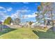 Large, fenced backyard with green grass and mature trees on a sunny day at 4217 Old Brick Ct, Raleigh, NC 27616