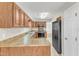 Kitchen with wood cabinets, stainless steel appliances, light countertops, and tile flooring at 4217 Old Brick Ct, Raleigh, NC 27616