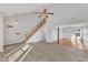 Spacious living room with wood-look floors, adjacent dining area, and large windows at 4217 Old Brick Ct, Raleigh, NC 27616