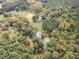 Aerial view of the home surrounded by lush trees, a pond, and natural beauty at 4322 Russell Rd, Graham, NC 27253
