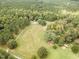 This aerial view captures the property's lush landscape, featuring mature trees, lawn, and a private drive at 4322 Russell Rd, Graham, NC 27253