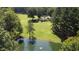 Expansive property with a pond, mature trees and a charming house nestled within a beautiful natural landscape at 4322 Russell Rd, Graham, NC 27253