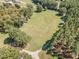 This expansive property features a long driveway, a lush lawn, and a serene treeline offering privacy at 4322 Russell Rd, Graham, NC 27253