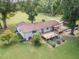 Back exterior view of home featuring an outdoor deck, landscaping, and lush greenery at 4322 Russell Rd, Graham, NC 27253