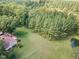 Aerial view of home, pond, and wooded lot at 4322 Russell Rd, Graham, NC 27253