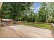 Large deck with metal railing overlooking wooded backyard at 4322 Russell Rd, Graham, NC 27253