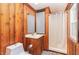 Rustic bathroom with wood paneling, stand-up shower, and a classic vanity sink at 4322 Russell Rd, Graham, NC 27253