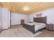 Cozy bedroom with wood ceiling, large bed, and colorful butterfly wall art at 4322 Russell Rd, Graham, NC 27253