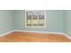 Bright bedroom featuring hardwood floors and a window with a view of the backyard at 4322 Russell Rd, Graham, NC 27253