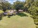 The home features a spacious yard, deck, and a red outbuilding, perfect for outdoor enjoyment and storage at 4322 Russell Rd, Graham, NC 27253