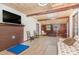 Comfortable living room with wood-paneled ceiling and accent wall, fireplace, and cozy seating at 4322 Russell Rd, Graham, NC 27253