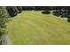 A vast, manicured lawn with mature trees surrounds this estate, offering both beauty and seclusion at 4322 Russell Rd, Graham, NC 27253