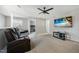 Upstairs living room with plush seating, a ceiling fan, and a large TV for entertainment at 503 Ganyard Farm Way, Durham, NC 27703