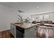 Kitchen island with a view of the living space and staircase at 506 Oak Forest View Ln, Wake Forest, NC 27587