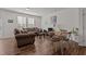 Cozy living room with natural light, comfortable seating, and wood floors at 506 Oak Forest View Ln, Wake Forest, NC 27587