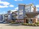 Modern apartment complex featuring a brick facade, metal accents, balconies, and covered parking at 515 N Churton St # 208, Hillsborough, NC 27278