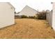 Wide-angle view of a serene backyard with a privacy fence and lush lawn at 5420 Golden Moss Trl, Raleigh, NC 27613