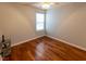 Small empty bedroom with hardwood flooring, offering a clean and neutral space at 5420 Golden Moss Trl, Raleigh, NC 27613