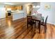 Dining area connected to the kitchen features hardwood floors and a view of the backyard at 5420 Golden Moss Trl, Raleigh, NC 27613