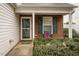 Inviting front porch area with brick accents and neatly trimmed landscaping at 5420 Golden Moss Trl, Raleigh, NC 27613