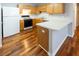 Functional kitchen with white appliances, ample counter space, and hardwood floors at 5420 Golden Moss Trl, Raleigh, NC 27613