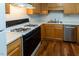 Well-lit kitchen featuring wood cabinets, laminate countertops, and an efficient gas range at 5420 Golden Moss Trl, Raleigh, NC 27613