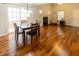 Open living space with hardwood floors, a dining area, and a fireplace at 5420 Golden Moss Trl, Raleigh, NC 27613