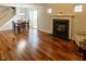Open-concept living room features hardwood floors, a fireplace, and ample natural light at 5420 Golden Moss Trl, Raleigh, NC 27613