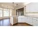 Bright kitchen with granite countertops, stainless steel appliances, and a farmhouse sink at 5508 Lake Edge Dr, Holly Springs, NC 27540