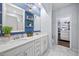 Luxurious bathroom boasting double sinks, granite countertop, custom cabinets, and an entryway to the closet at 5520 Advancing Ave, Raleigh, NC 27616