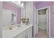 Dual access bathroom with white vanity, quartz countertop, and decorative vase featuring elegant and modern fixtures at 5520 Advancing Ave, Raleigh, NC 27616