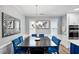 Formal dining room showcasing butterfly art, blue velvet chairs and direct access to the kitchen at 5520 Advancing Ave, Raleigh, NC 27616