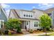 Beautiful two-story home featuring a covered front porch and professionally landscaped front yard at 5520 Advancing Ave, Raleigh, NC 27616