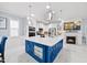 Bright, open-concept kitchen with a large island with a white countertop, modern appliances, and cozy fireplace at 5520 Advancing Ave, Raleigh, NC 27616