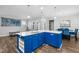 This kitchen features a blue island, pendant lighting, and an eat-in dining area at 5520 Advancing Ave, Raleigh, NC 27616
