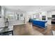 Bright open floor plan and kitchen features a large blue island, stainless appliances, and dining area at 5520 Advancing Ave, Raleigh, NC 27616