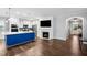 Open floor plan living room with a fireplace that leads to a sleek, modern kitchen space at 5520 Advancing Ave, Raleigh, NC 27616