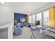 Stylish living room with modern decor, large windows, and unique light fixture offering a bright and inviting space at 5520 Advancing Ave, Raleigh, NC 27616
